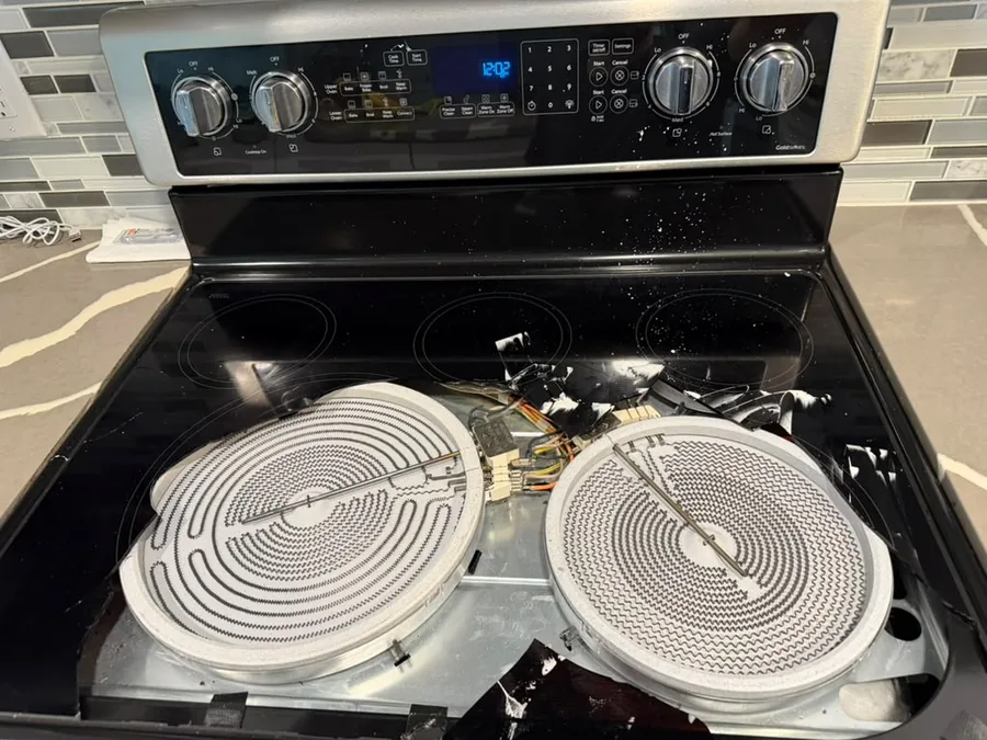 Electric range cooktop opened for element repair