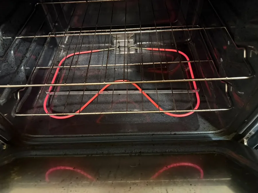 Oven heating element tested during repair